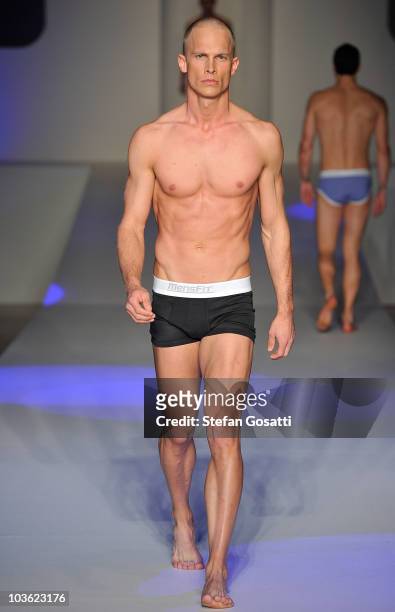 Model showcases designs by Mensfit on the catwalk during the Man And Woman by Peter Morrissey, Dr Rey's Shapewear and Mensfit group show as part of...