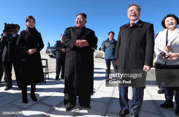 North Korean leader Kim Jong Un and his wife Ri Sol Ju applaud with South Korean President Moon Jae-in and his wife Kim Jung-sook as they arrive at...