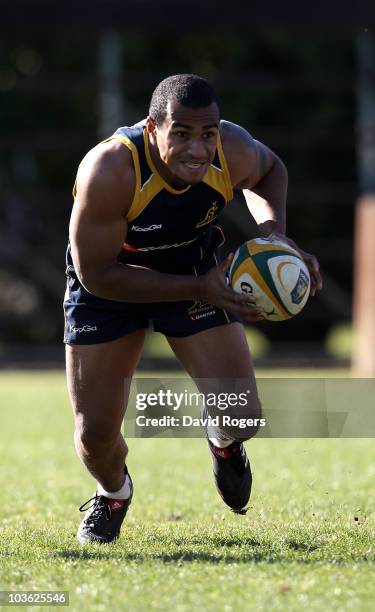 Will Genia runs with the ball during an Australian Wallabies training session at Bishops High School on August 25, 2010 in Cape Town, South Africa.