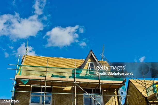 scaffolding around a roof - replacement stock pictures, royalty-free photos & images