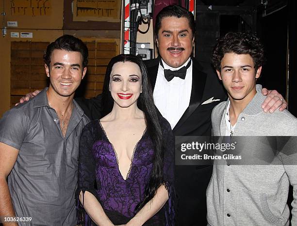 *Exclusive Coverage* Kevin Jonas, Bebe Neuwirth as "Morticia Addams", Merwin Foard as "Gomez Addams" and Nick Jonas pose backstage at The Addams...