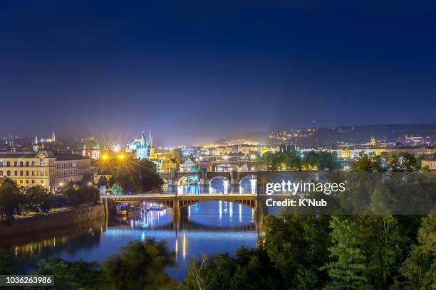 aerial view of st. charles bridge and old town tower with crowd of people travel on the bridge at night after sunset time at prague, czech republic, europe - k'nub stock pictures, royalty-free photos & images