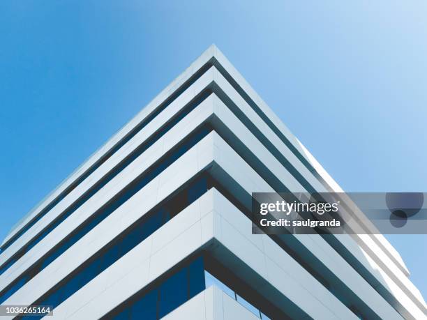 low angle view of building corner against clear blue sky - low angle view stock pictures, royalty-free photos & images