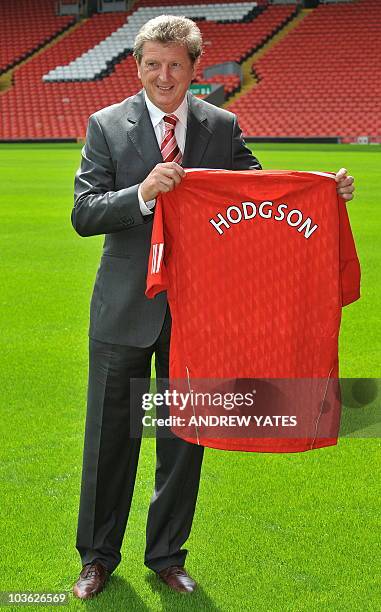 Liverpool Football Club's new manager, Roy Hodgson, poses for photographers with a team shirt, at their Anfield stadium in Liverpool, northwest...