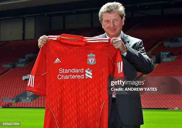 Liverpool Football Club's new manager, Roy Hodgson, poses for photographers with a team shirt, at their Anfield stadium in Liverpool, northwest...