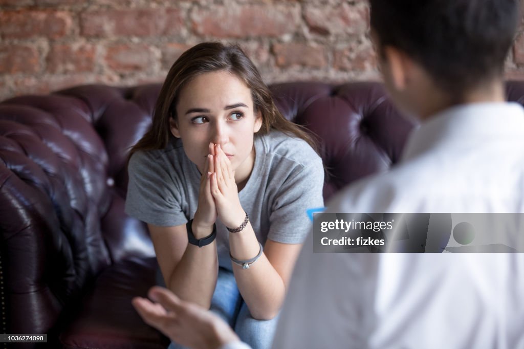 Unhappy young girl at the psychologist