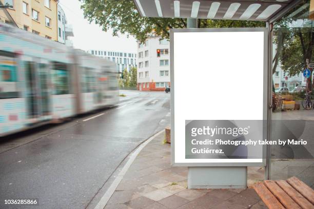 tram stop with billboard - placard stock-fotos und bilder