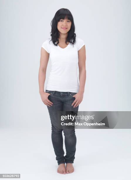 young asian female with hands in pockets  - jeans barefoot fotografías e imágenes de stock