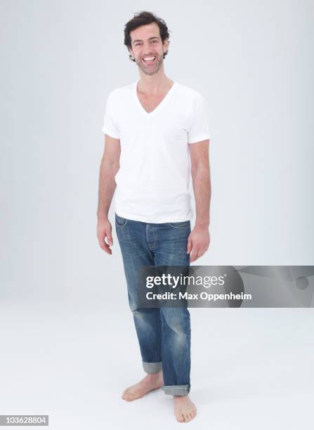 portrait of smiling man with trimmed beard  - jeans barefoot stock pictures, royalty-free photos & images