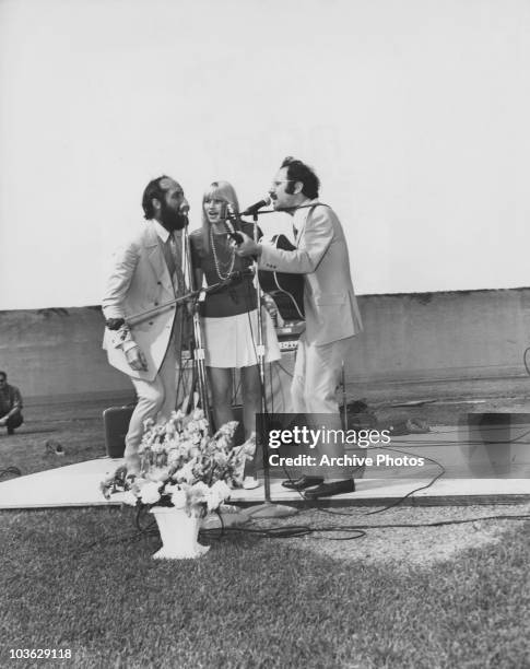 American folk trio Peter, Paul and Mary perform outdoors at the Illinois State Penitentiary, Stateville at Joliet, Illinois, circa 1965.