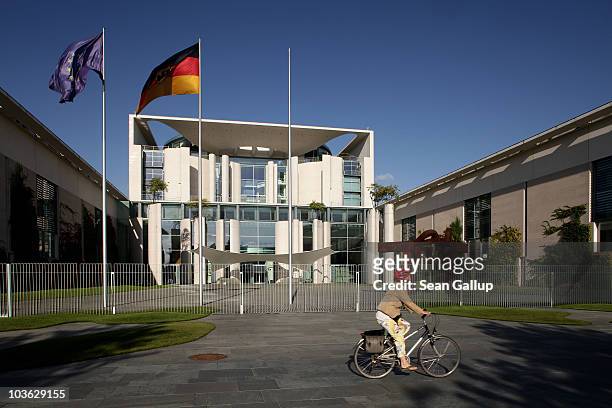 Woman on a bicycle rides past the Chancellery on August 25, 2010 in Berlin, Germany. The Chancellery houses the offices of German Chancellor Angela...