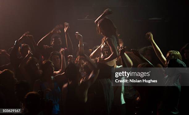 crowd dancing in nightclub - locale notturno foto e immagini stock