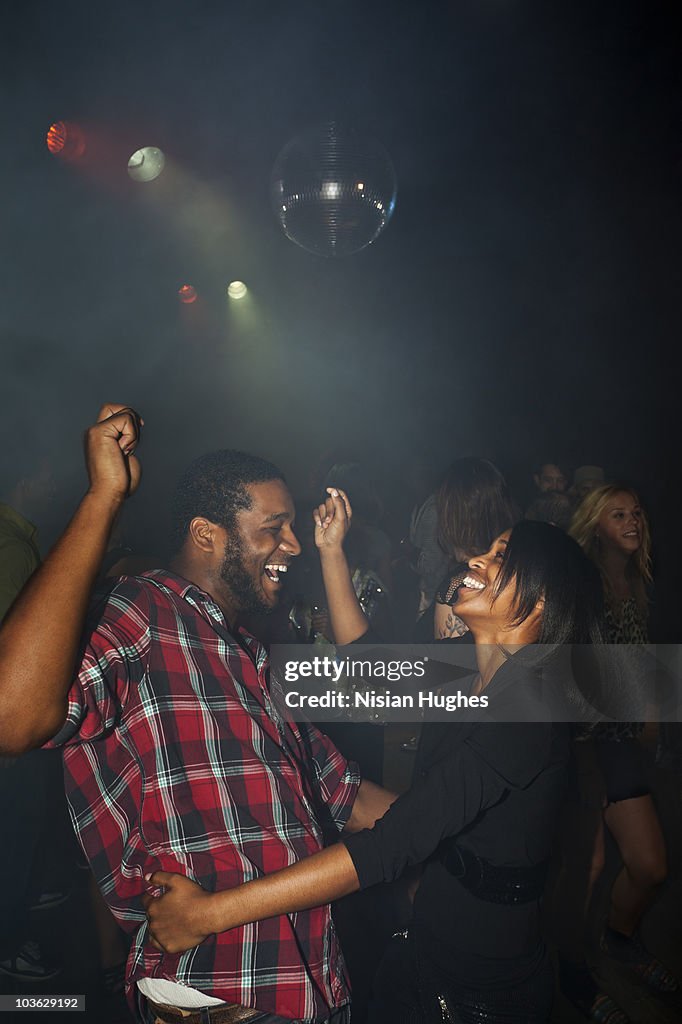Couple dancing together in nightclub