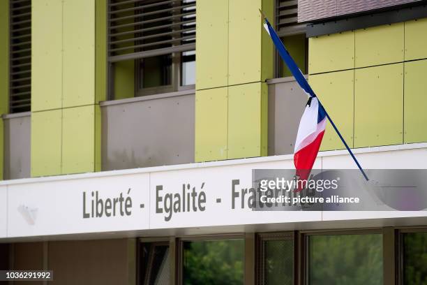 Black ribbon bound around the French flag at the town hall in Saint-Quentin Fallavier, France, 27 June 2015. A man was killed in an attack on an...