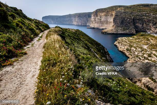hiking path, cliffs nearby xlendi tower, ras il-bajda, xlendi, gozo, malta - gozo stock pictures, royalty-free photos & images