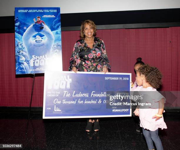 Roberta Shields receives a check for The Ludacris Foundation during the 'Smallfoot' special screening with The Ludacris Foundation at Regal Atlantic...