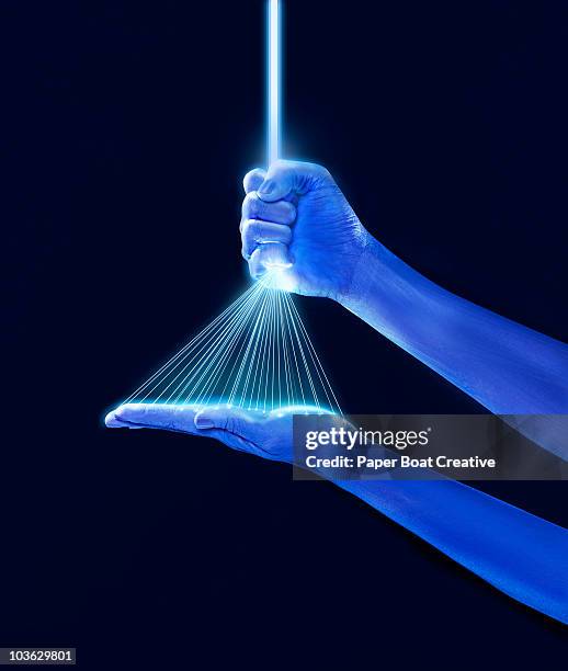 blue hands holding a group of laser beams - art and science stockfoto's en -beelden