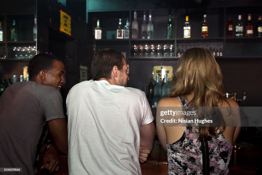 People leaning on bar