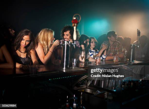 people at bar in nightclub - setting the bar stock pictures, royalty-free photos & images