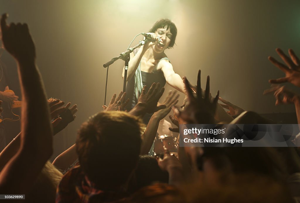 Woman singing into microphone