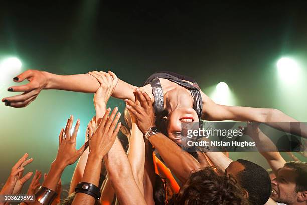 music performer crowd surfing - crowdsurfing stock pictures, royalty-free photos & images