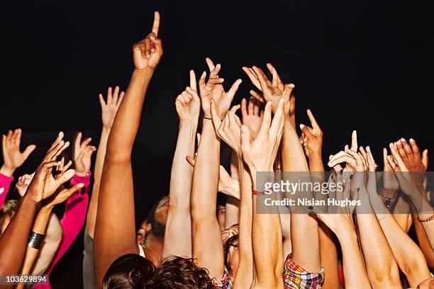 large crowd with hands up - arms raised stock pictures, royalty-free photos & images