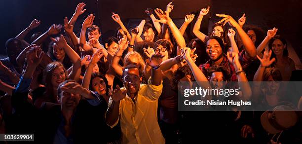 large crowd pointing at camera - concert crowd stockfoto's en -beelden