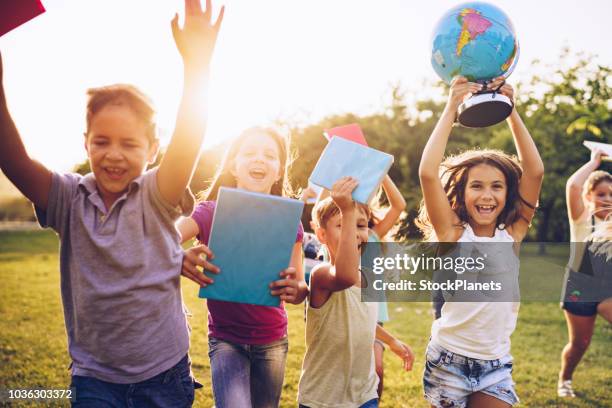 happy kids running on sunset - students map imagens e fotografias de stock