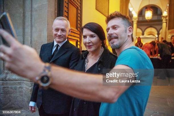 Artist Marina Abramovic and partner Todd Eckert take a selfiewith an Italian fan before the dinner party in her honour for the exhibition 'Marina...