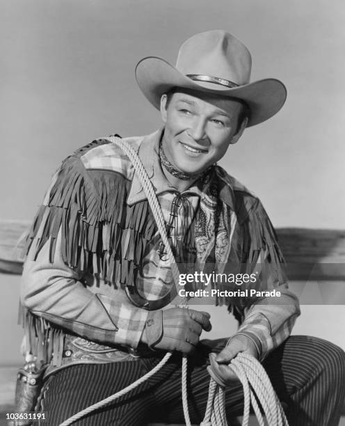 Singer and actor Roy Rogers , 'King of the Cowboys', in his cowboy suit, holding a lasso on 'The Roy Rogers Show', USA, circa 1955.