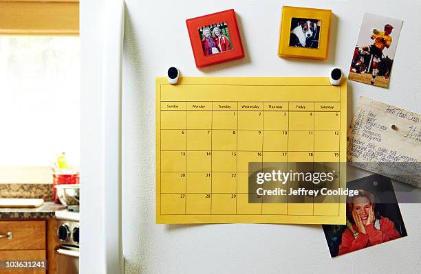 calendar on refrigerator - magnet foto e immagini stock