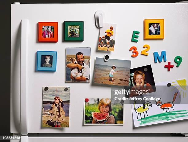 family photos on refrigerator - refrigerator stock-fotos und bilder