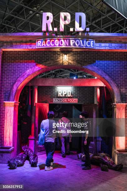 Attendees walk into the Capcom Co. Biohazard game demonstration booth during a media preview day of the Tokyo Game Show in Chiba, Japan, on Thursday,...