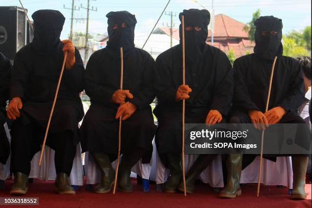 The flogging enforcers seen before whipping the prisoners. 19 people were sentenced by the Meulaboh Sharia Court to being whipped in public for...