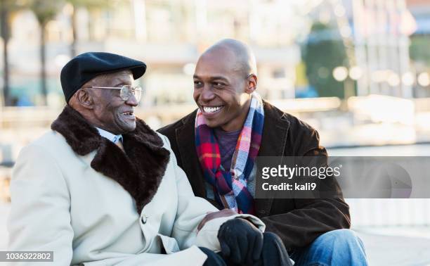 African-American man with grandfather In city