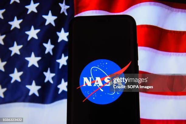 In this photo illustration, the National Aeronautics and Space Administration logo is seen displayed on an Android mobile phone.