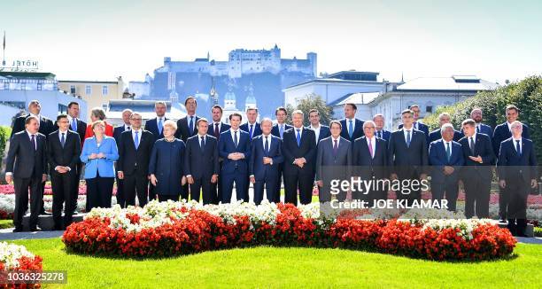 Participants pose for a family photo during the EU Informal Summit of Heads of State or Government in Salzburg, Austria, on September 20, 2018 :...