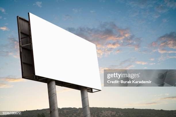 blank billboard on the side of the road - billboard highway stock-fotos und bilder