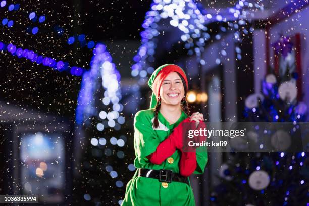 elf op winter festival - woman snow outside night stockfoto's en -beelden