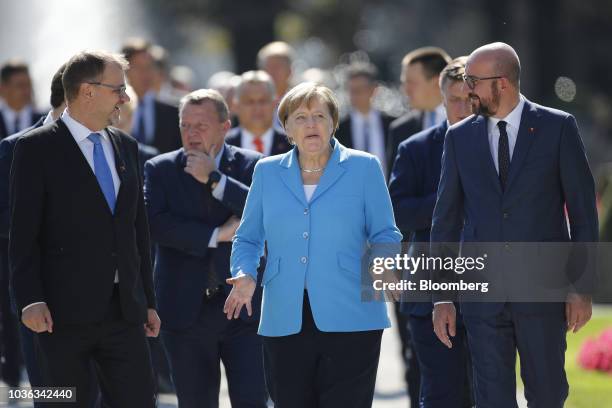 Angela Merkel, Germany's chancellor, center, speaks with Juha Sipila, Finland's prime minister, left, and Charles Michel, Belgium's prime minister,...