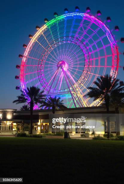 Ferris wheel is illuminated in rainbow colours to commemorate the vicitims of a mass shooting in Orlando, Florida, USA, 13 June 2016. Photo: George...