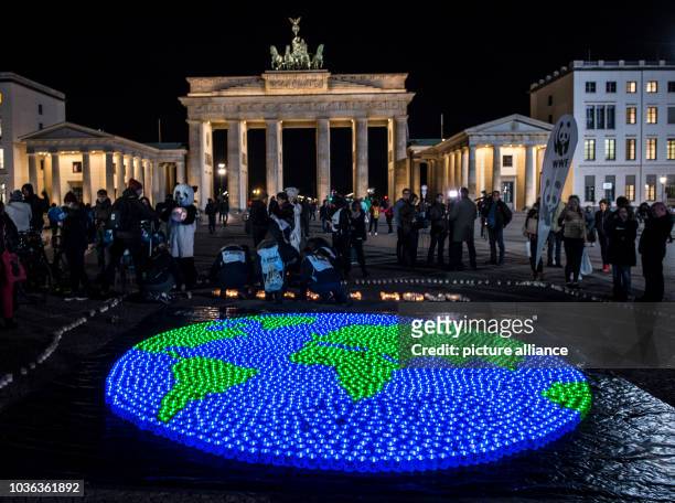 Globe of LED lights are lit up for the international "Earth Hour" in Berlin, Germany, 25 March 2017. Photo: Paul Zinken/dpa | usage worldwide