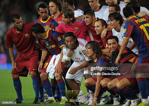 Ronaldinho of AC Milan joined his former Barcelona teammates after the Joan Gamper Trophy match between Barcelona and AC Milan at Camp Nou stadium on...