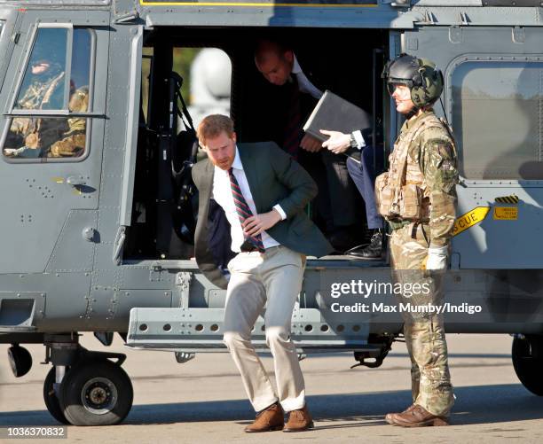 Prince Harry, Duke of Sussex disembarks a Royal Navy Wildcat Maritime Attack Helicopter as he arrives for a visit to The Royal Marines Commando...