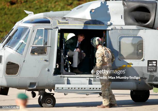 Prince Harry, Duke of Sussex disembarks a Royal Navy Wildcat Maritime Attack Helicopter as he arrives for a visit to The Royal Marines Commando...