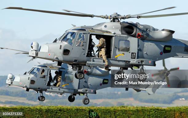 Two Royal Navy Wildcat Maritime Attack Helicopters depart The Royal Marines Commando Training Centre after transporting Prince Harry, Duke of Sussex...