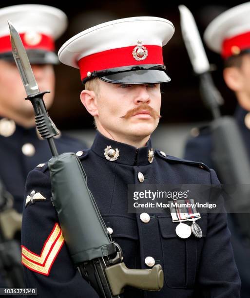 Moustachioed Royal Marine Commando forms part of an honour guard at The Royal Marines Commando Training Centre ahead of a visit by Prince Harry, Duke...
