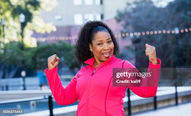 senior african-american woman exercising in city - old fat lady stock pictures, royalty-free photos & images