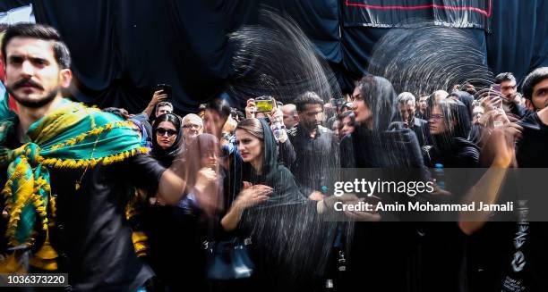 Iranian Shiite Muslims pray in Tehran during annual Ashura commemorations marking the martyrdom of Imam Hussein, the grandson of Islam's Prophet...