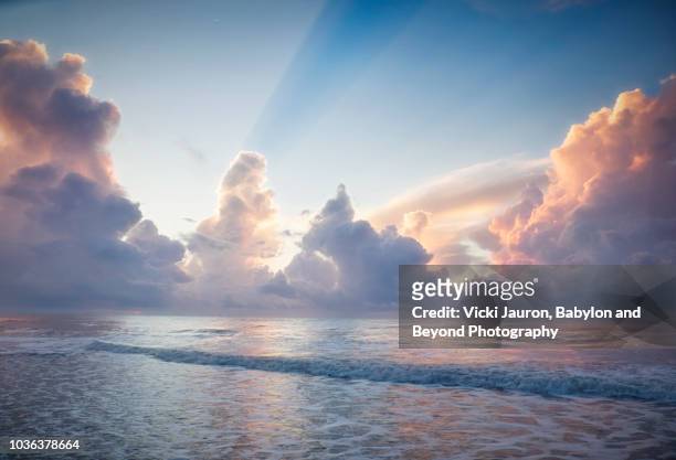 soft blue and sun rays at sunrise on myrtle beach, south carolina - sunbeam clouds stock pictures, royalty-free photos & images
